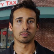 Man with dark hair and the beginnings of a mustache and goatee